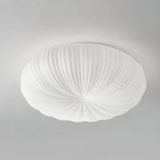 Close up product shot of white Bobby flush ceiling light showing ribbed PE acrylic diffuser detail on grey background