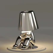 Silver RayDudes sunset lamp in baffled confounded crouching pose on white stand
