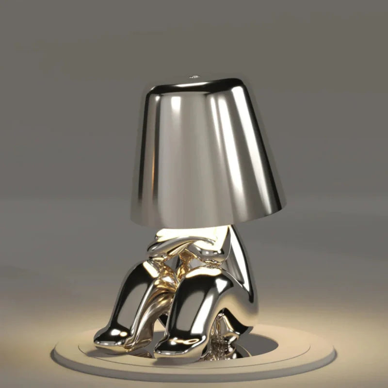 Silver RayDudes sunset lamp in baffled confounded crouching pose on white stand