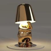 Gold RayDudes sunset lamp in contemplative thoughtful sitting pose on white stand