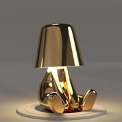 Gold RayDudes sunset lamp in dismayed hunching pose with warm amber glow