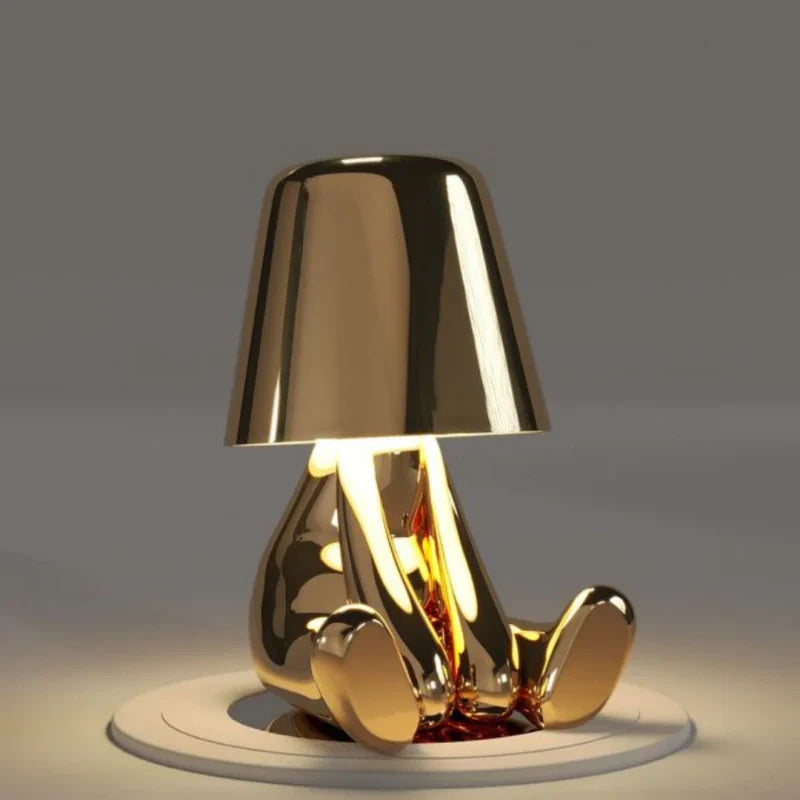 Gold RayDudes sunset lamp in dismayed hunching pose with warm amber glow